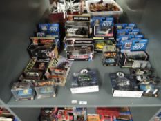 A shelf of Corgi and similar James Bond 007 die-casts, many films covered, 28 in total, all boxed or