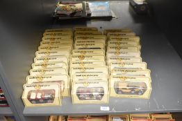 A shelf of Lledo Models of Yesteryear die-casts, Vintage Cars, 32 in total, all in window display