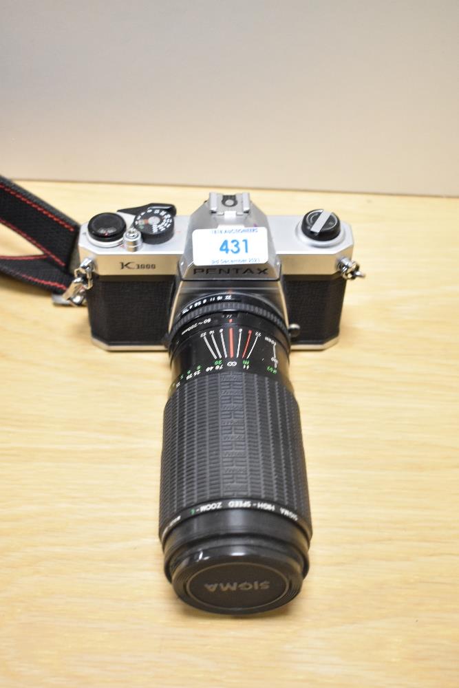 A Pentax K1000 camera No5385153 with Sigma High speed zoom 1:3,5-5,4 f80-200mm lens No505623 in soft