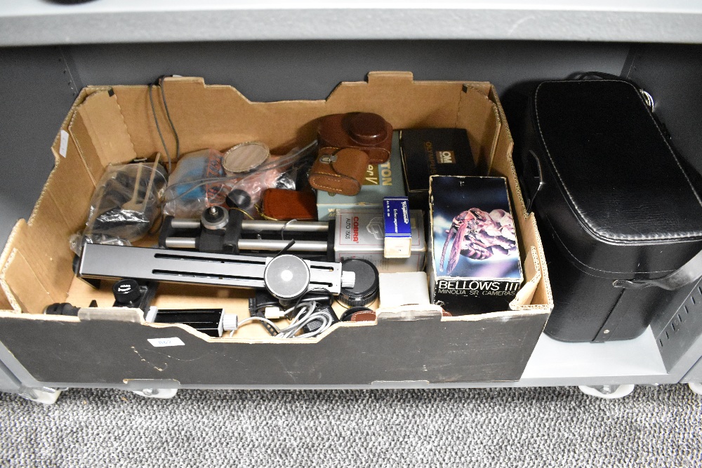 A box containing photographic equipment including Bellows, Light meters, Grips, Flash guns,