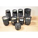 Ten Hanimex lenses. A 1:4,5 200mm, three Auto Zoom MC 1:3,5-4,5 28-80mm, a Auto Zoom MC Macro 1:3,