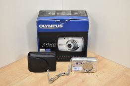 An Olympus Digital 600 camera in original box with charger and booklet
