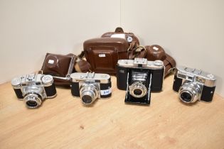 Four cameras. A Zeiss Ikon Nettar, a Voigtlander Vito B, a Voigtlander Vitomatic II, and a Braun