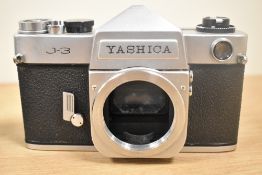 Three Yashica camera bodies. An Electro AX, a J-3 and a Minister III