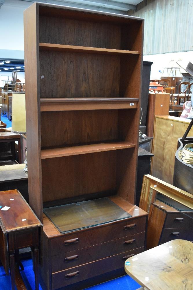 A vintage teak wall unit having partially glazed shelves and drawer base, dimensions approx.