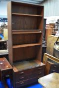 A vintage teak wall unit having partially glazed shelves and drawer base, dimensions approx.