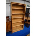A modern golden oak effect bookcase, approx dimensions W100 H200 D31cm