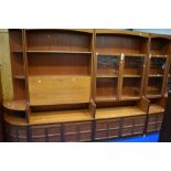 A run of Nathan wall units including two corner ends, wide and narrow glazed displays and bureau/