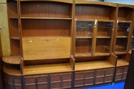 A run of Nathan wall units including two corner ends, wide and narrow glazed displays and bureau/