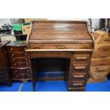 An early 20th Century oak roll top desk of small proportions, width approx 92cm, height 112cm