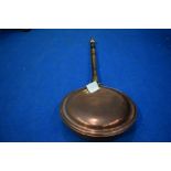 A traditional copper warming pan and reproduction corner whatnot