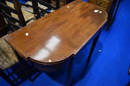 An Edwardian mahogany fold over tea table on square tapered legs, width approx 94cm