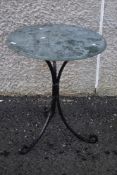 A garden table having slate top and wrought iron frame