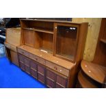 A vintage teak sideboard/dresser by Nathan, having cocktail and display section over triple frieze