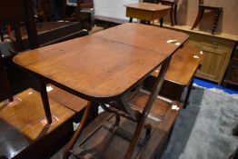 A 19th Century mahogany folding butlers serving table having shaped legs and turned supports, approx