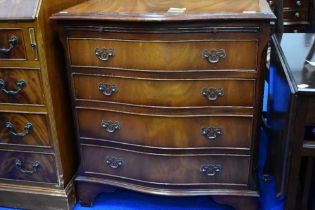A reproduction Regency style serpentine fronted chest of four long drawers, with brushing slide,