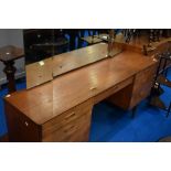 A vintage teak dressing table, width approx 112cm