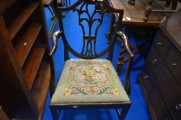 A 19th Century shield back carver chair with tapestry drop in seat