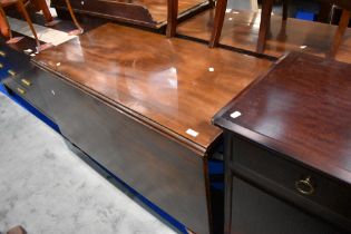 A 19th Century mahogany banquetting table comprising rectangular gateleg centre and two D ends