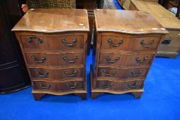 A pair of reproduction yew wood serpentine bedside drawers, approx. dimensions each W48cm D40cm