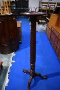 A reproduction mahogany torchere , height approx. 131cm