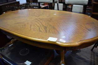 A reproduction coffee table having shaped oval top, with ball and claw feet, approx 127 x 72cm