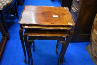 An early 20th Century walnut nest of three tables on cabriole legs, largest table width approx.