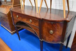 A Regency mahogany sideboard having central drawer above recess , flanked by cupboard , cellarette