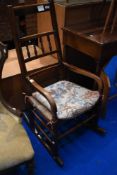 A traditional spindle back rocking chair having rush seat