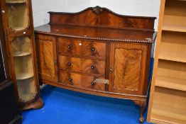 A 19th Century mahogany sideboard having ledge back and three central drawers flanked by cupboards