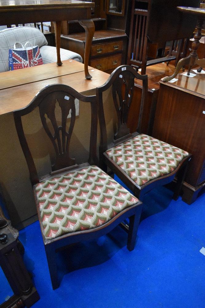 A pair of 19th mahogany slat back dining chairs having drop in woolwork seats