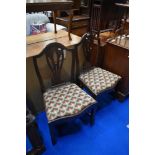 A pair of 19th mahogany slat back dining chairs having drop in woolwork seats