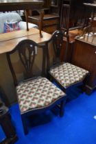 A pair of 19th mahogany slat back dining chairs having drop in woolwork seats