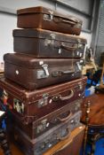 A selection of vintage luggage cases, including leather , some with travel labels