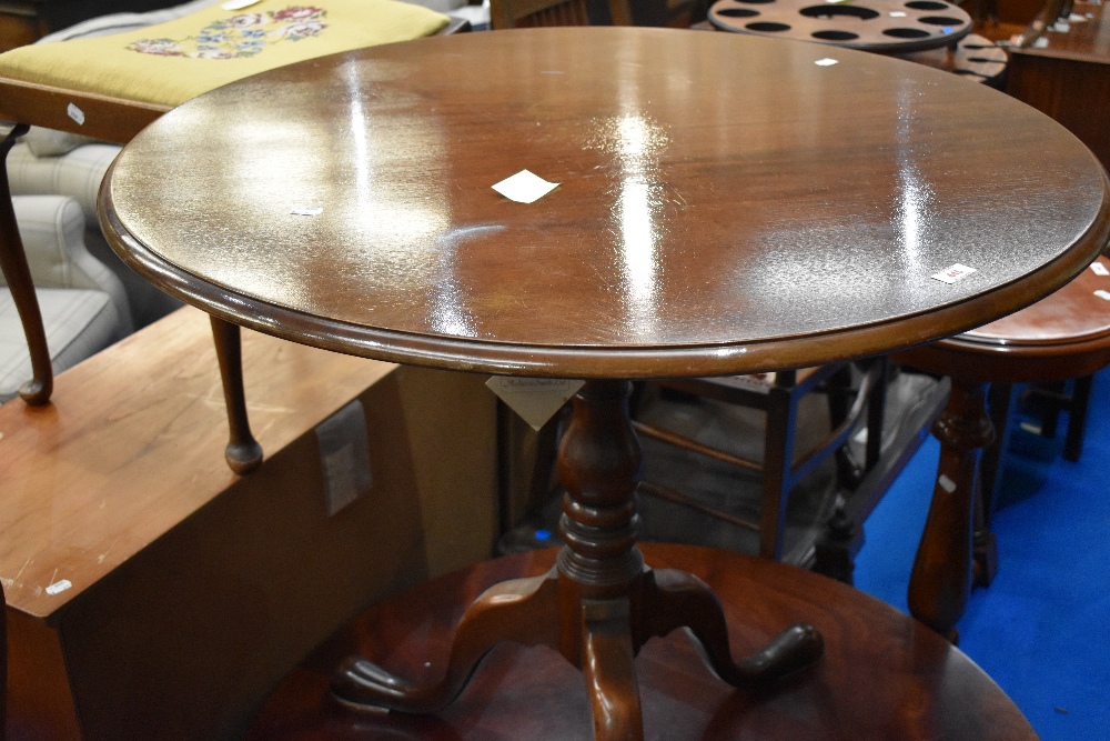 A reproduction pedestal dining table having circular top , birdcage tilt top mechanism, diameter