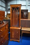 A reproduction yew wood narrow display unit, height approx. 190cm, width 56cm
