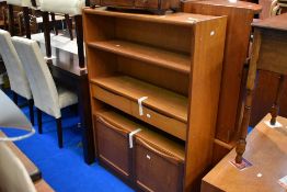 A Nathan teak bookshelf with central drawer section and cupboard base