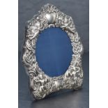 A Queen Elizabeth II silver mounted photograph frame, of shaped outline, with circular aperture, the
