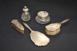 A Queen Elizabeth II silver three-piece brush and mirror set, comprising hand mirror, hair and