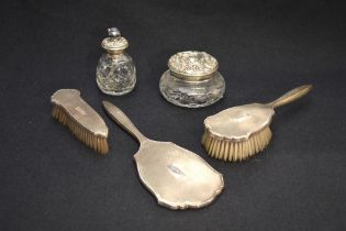 A Queen Elizabeth II silver three-piece brush and mirror set, comprising hand mirror, hair and