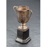 A George V silver trophy, of two-handled cylindrical form with short knopped stem and canted