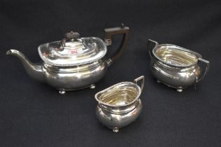 A George V silver three-piece silver teaset, of moulded and rounded rectangular form with egg-and-