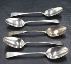 A group of three George IV silver Old English Pattern dessert spoons, each with engraved lion