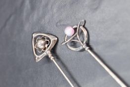 Two George V silver topped Charles Horner hat pins, one with stylised triangle and sphere