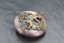 A Chinese white metal-mounted purple and blue hard stone pendant, of circular form with white