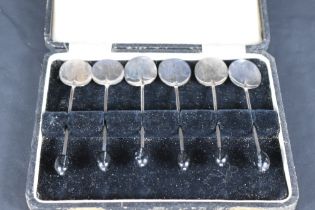 A cased set of six George V silver coffee bean spoons, of traditional form with shallow circular