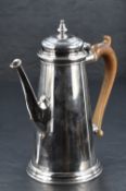 A Queen Elizabeth II silver coffee pot, of spreading cylindrical form with finial topped, moulded