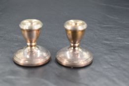 A pair of Queen Elizabeth II silver squat candlesticks, of tapering and spreading form with reeded