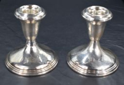A pair of American Sterling squat candlesticks, of tapering and spreading circular form with moulded
