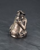 An Edwardian silver 'Mr Punch' novelty pepperette, of moulded figural form with weighted screw-off